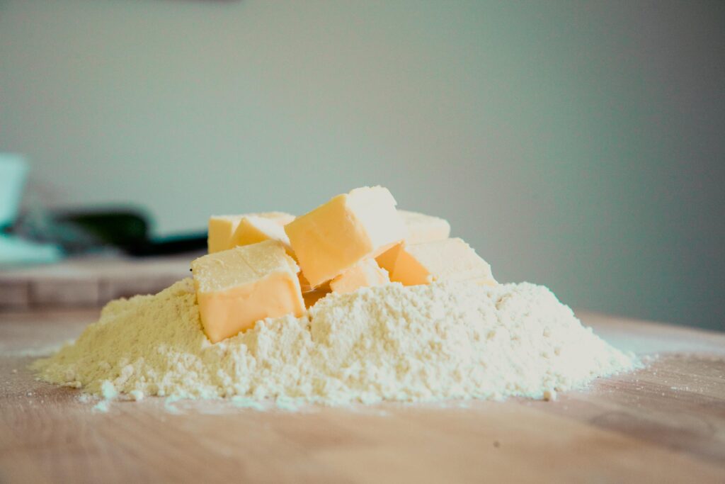 pexels-photo-94443-94443 Close-up of butter and flour on a kitchen counter, perfect for baking.